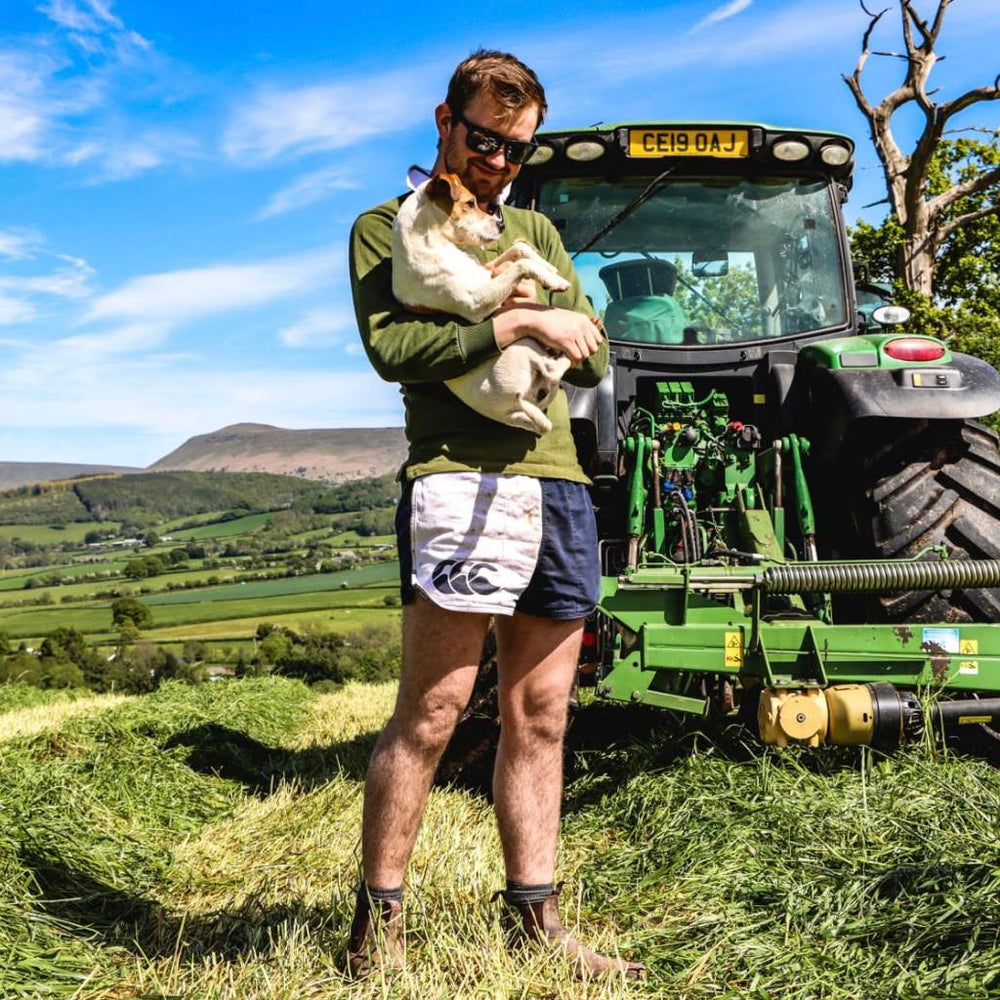 
                  
                    Man wearing the Canterbury Clothing New Zealand range and holding a dog
                  
                