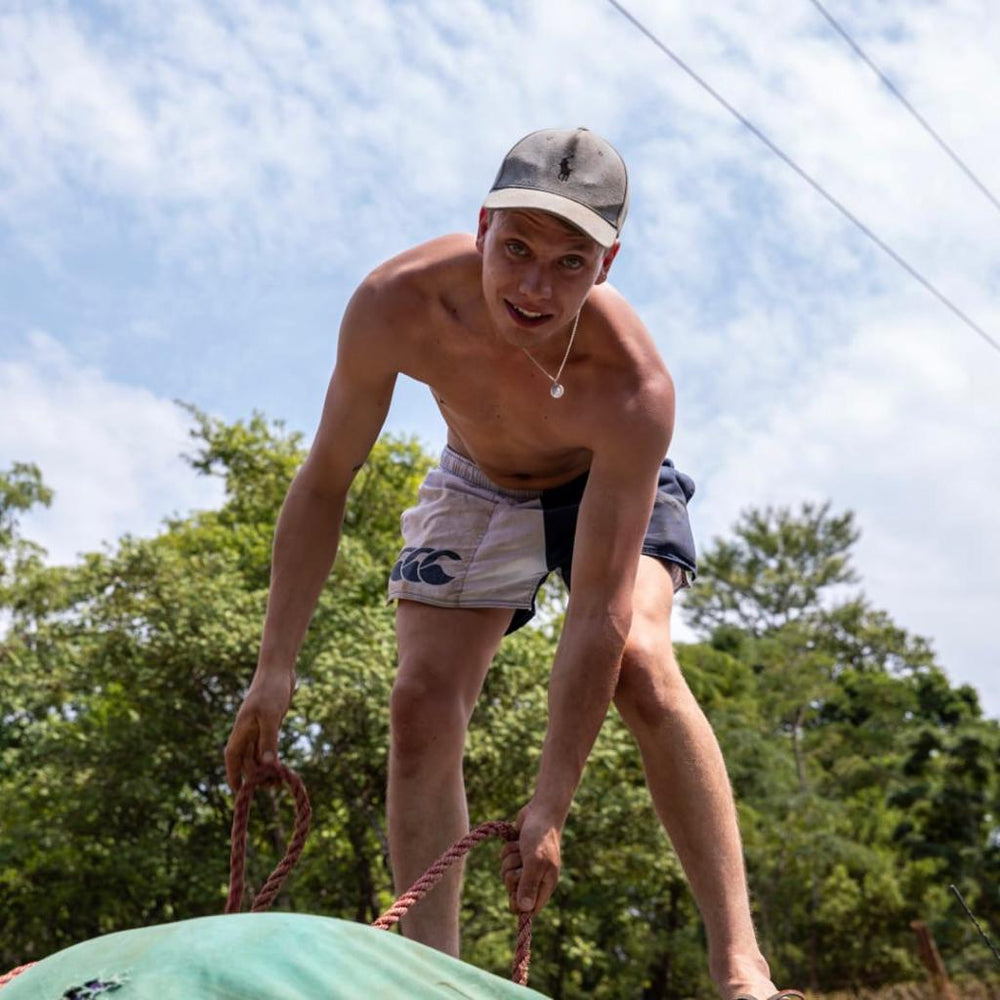 
                  
                    Shirtless man wearing white and navy Canterbury harlequin shorts
                  
                