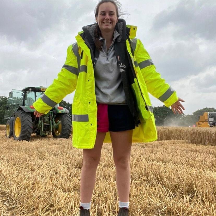 
                  
                    Woman wearing clothing for farmers, including the iconic CCC shorts
                  
                