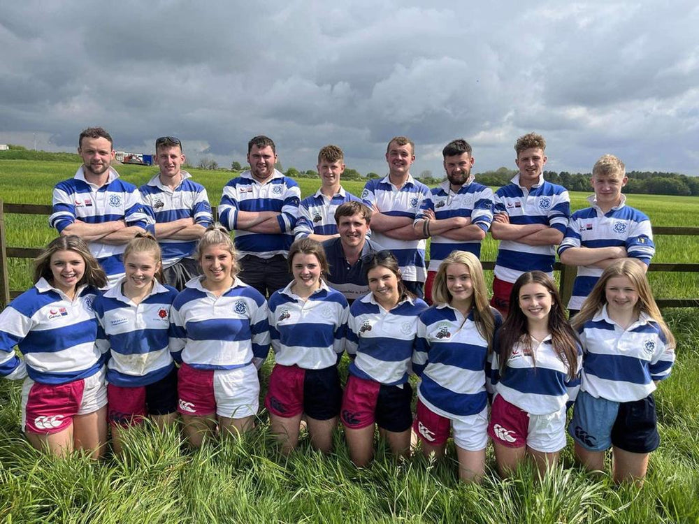 
                  
                    Rugby team wearing pink and white canterbury shorts and posing for the camera
                  
                