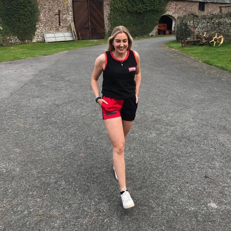 Woman walking and wearing Canterbury harlequin shorts