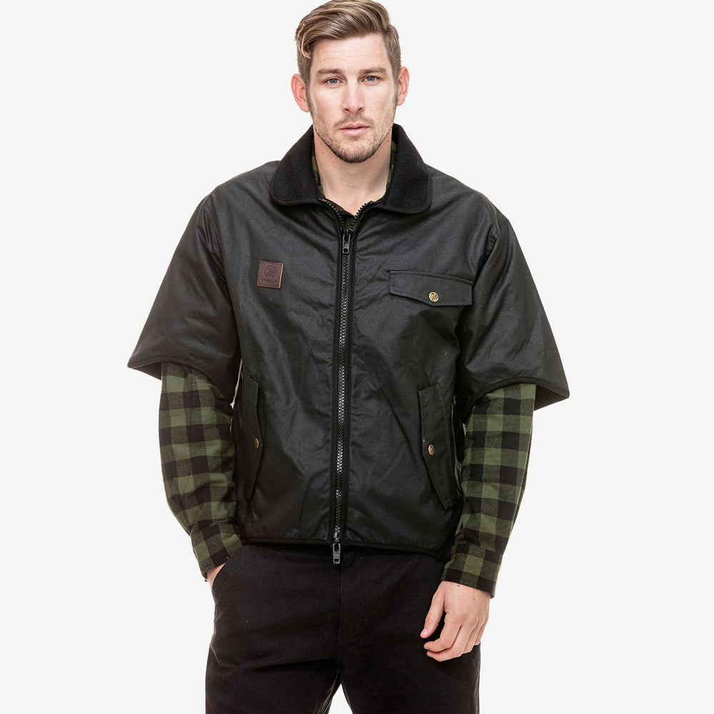 Model wearing oilskin jacket and a checkered shirt underneath